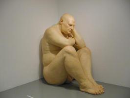 View showing entire scultpture (a huge, fat, bald man)