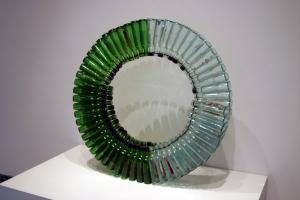 Spiral wheel made of empty clear and green bottles