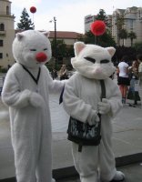 two such cat-like animals; both have an antenna with a red ball on their heads
