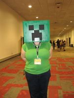 Woman with a mask that looks like a character from an 8-bit video game.