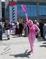 Woman in pink unitard twirling gymnastic ribbon