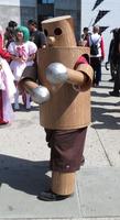 Person in costume made of wooden cylinders