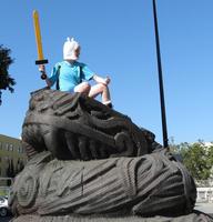 Female warrior character atop Quetzalcoatl sculpture in downtown San Jose