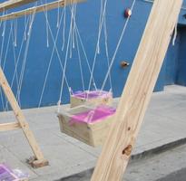 Swinging boxes with moving objects inside to make percussive sounds