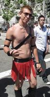 Shirtless guy in red leather skirt