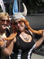 Woman wearing Viking opera lady hat with long red/orange braided 